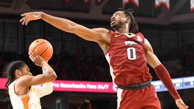 The Razorbacks Stanley Umude tries to block Tennessee's Santiago Vescovi at Bud Walton Arena.